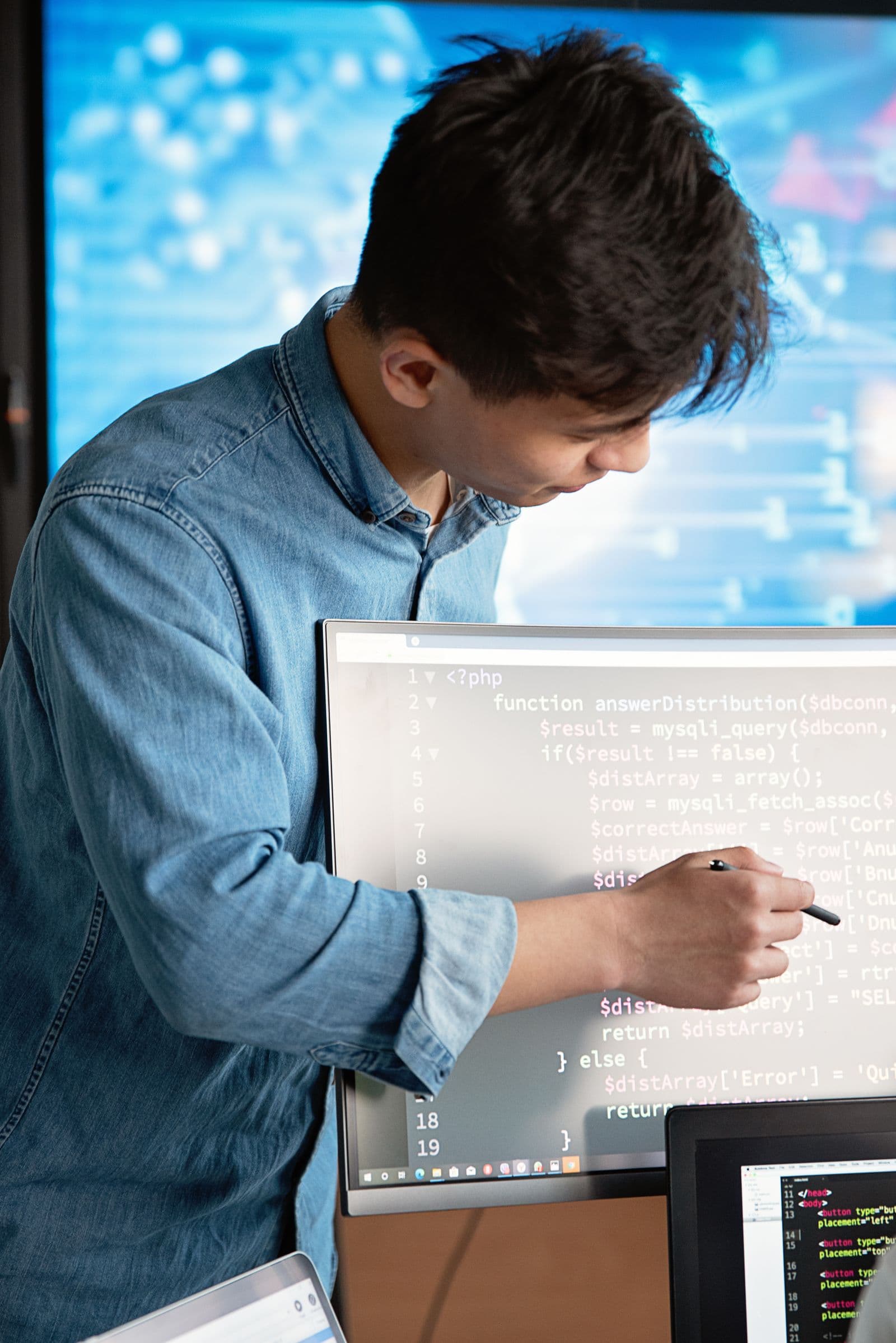 Software developer reviewing code on a monitor